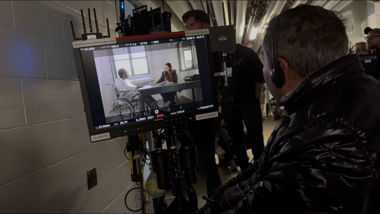 DaSilva on set, viewing a scene on the director's monitor.